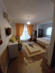 a living room with a bed and a couch at Jasmin Apart Otel in Göcek