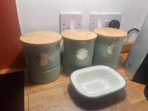 a group of three trash cans sitting next to a toilet at 45 Mold Road in Wrexham