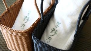a basket filled with white towels with embroidery on it at Onyado Nono Sendai Natural Hot Spring in Sendai