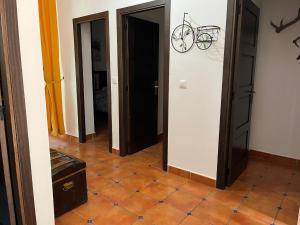 a hallway with three doors and a bike on the wall at CASA RURAL PEPICHE 