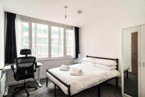 a bedroom with a bed and a desk and a chair at Smart 1 Bed Central Preston Apartment in Preston