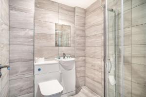 a bathroom with a shower and a toilet and a sink at Smart 1 Bed Central Preston Apartment in Preston