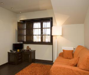 a living room with a couch and a table and a window at Apartamentos Viavelez in La Caridad