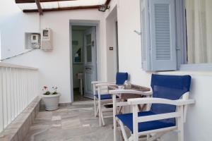 a patio with chairs and a table on a building at House in Castle in Parikia
