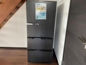 a stainless steel refrigerator with a sign on it at Private sauna stay Shinori - Vacation STAY 34530v in Hakodate