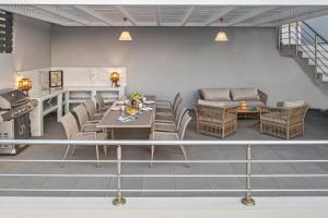 a living room with a table and chairs at Articiano Villa in Faliraki +40 photos