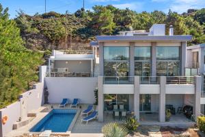 an aerial view of a house with a swimming pool at Articiano Villa in Faliraki