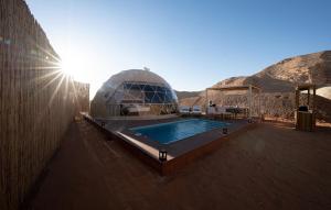 a dome house with a swimming pool in the desert at PAUSEAWAY at Tuwaiq House in Riyadh