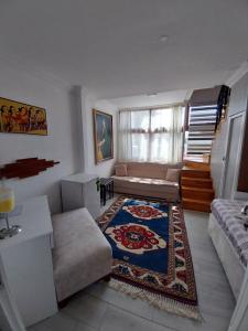 a living room with a couch and a rug at Jasmin Apart Otel in Göcek