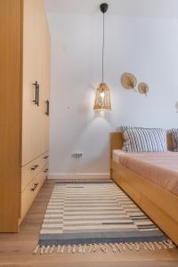 a bedroom with a bed and a rug on the floor at Apartment Tulip in Varna City