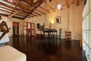 a living room with a table and chairs and a tv at Just For Fun B&B in Pingxi