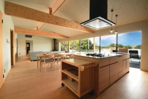 a kitchen and dining room with a large window at MOKU ISESHIMA ーl モク伊勢志摩 lー in Shima