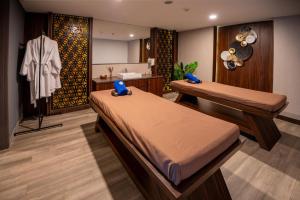 a bedroom with two beds and a dressing room at ASTON Sorong Hotel & Conference Center in Sorong