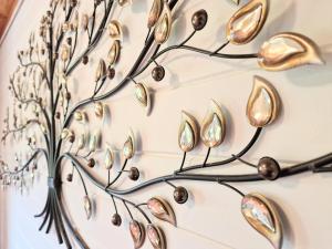 a metal tree with silver and gold decorations on a wall at Otter 2 HuntersMoon- Warminster-Wiltshire-Bristol in Warminster