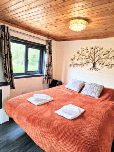 ein Schlafzimmer mit einem Bett mit zwei Handtüchern darauf in der Unterkunft Otter 2 HuntersMoon- Warminster-Wiltshire-Bristol in Warminster