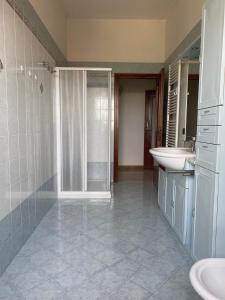 a bathroom with a shower and a sink and a toilet at Torrione view apartment in Spilamberto