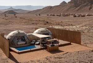 two domes in the middle of the desert at PAUSEAWAY at Tuwaiq House in Riyadh