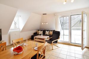 a living room with a couch and a table at FeWo Ahoi - 73 qm maritime Gemütlichkeit auf zwei Ebenen in Ostseebad Koserow