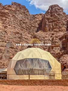 a dome tent in front of a rock wall at Rum Laverne Luxury Camp in Wadi Rum