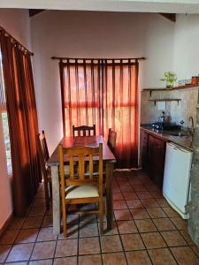 a kitchen with a table and chairs in a room at Tinkuy in Cosquín