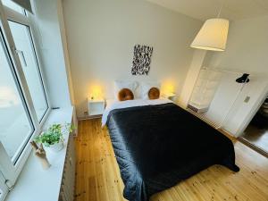 a bedroom with a large bed with a black blanket at aday - Randers cozy 1 bedroom apartment in Randers