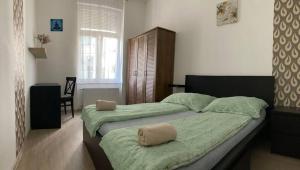 Posteľ alebo postele v izbe v ubytovaní West Residence