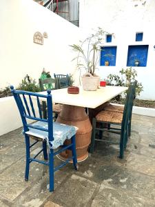 a table and two chairs sitting next to a table with a plant at Samia Seavilla Pythagorio in Pythagoreio