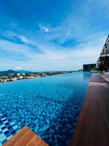 a large swimming pool with a view of a city at The Horizon Ipoh Infinity Pool 17th floor in Ipoh