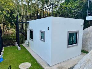 a white house with a balcony on top of it at Lamtam Maesa Resort ลำธารแม่สา รีสอร์ท in Mae Rim +69 photos