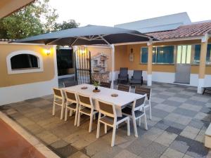 un tavolo e sedie sotto un ombrellone su un patio di O Nosso Cantinho (private pool) a Casais da Carneiria