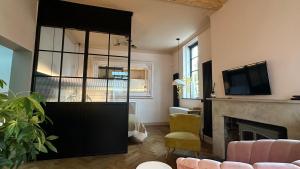 a living room with a large glass door with a fireplace at The Annexe in Stockport