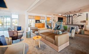 a living room with couches and chairs at Lindner Hotel Boltenhagen, part of JdV by Hyatt in Boltenhagen