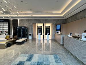 a lobby with two elevators in a building at Tuke China Hotel Shanghai Hongqiao Airport in Shanghai