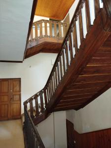 a staircase in a house with wooden railings at La Cadisserie en Gévaudan in Marvejols