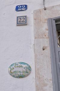 a building with a sign on the side of it at Casa Coppaiaia - Spaziosa e luminosa nel centro storico in Martina Franca