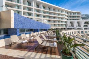 a row of chairs on the balcony of a hotel at Sesimbra Oceanfront Hotel - Preferred Hotels and Resorts in Sesimbra