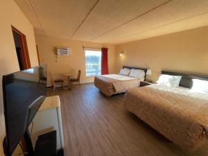 Postel nebo postele na pokoji v ubytování Motel St-Eustache