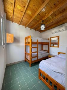 a bedroom with two bunk beds and a wooden ceiling at Auski Hostel Dahab in Dahab