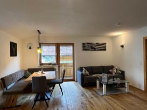 a living room with a couch and a table at Alpentime Apartments in Neustift im Stubaital +8 photos