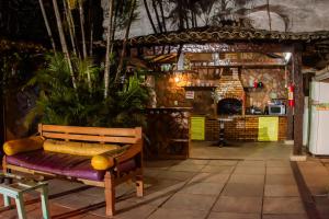 a bench sitting in a room with a bar at Solar Hostel Búzios in Búzios