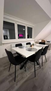 a dining room with a white table and chairs at Reviv - Traumhaftes 3 Zimmer Apartment in Brühl