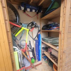 a closet with a bicycle and other tools in it at Traumhaftes Ferienhaus LENA direkt an der Ostsee in Łukęcin