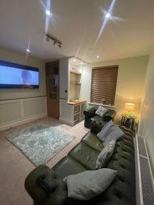 a living room with a couch and a flat screen tv at Impeccable 3-Bed House in York in York