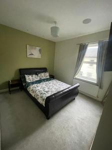 a bedroom with a bed and a window at Impeccable 3-Bed House in York in York