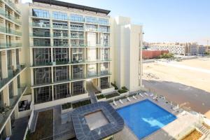 an overhead view of a building with a swimming pool at Silk Valley - Furnished 1bhk With Pool And Gym in Abu Dhabi