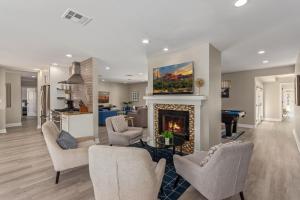 a living room with a fireplace with a painting above it at Scottsdale - 4826 N 69th St in Scottsdale