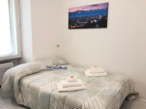 a bedroom with a bed with two towels on it at House Vincent by Holiday World in Turin