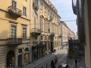 a city street with buildings and people walking on the street at House Vincent by Holiday World in Turin