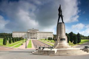 a statue of a man on top of a monument in front of a building at Belfast Luxury: Spacious 2BR Home Near Stormont in Belfast
