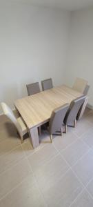 a wooden table and chairs in a room at Pension Wolfi in Gersdorf